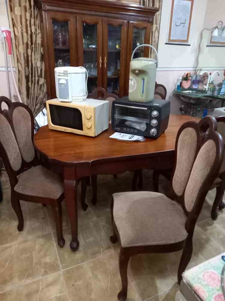Genuine teak dining table with six cushioned chairs